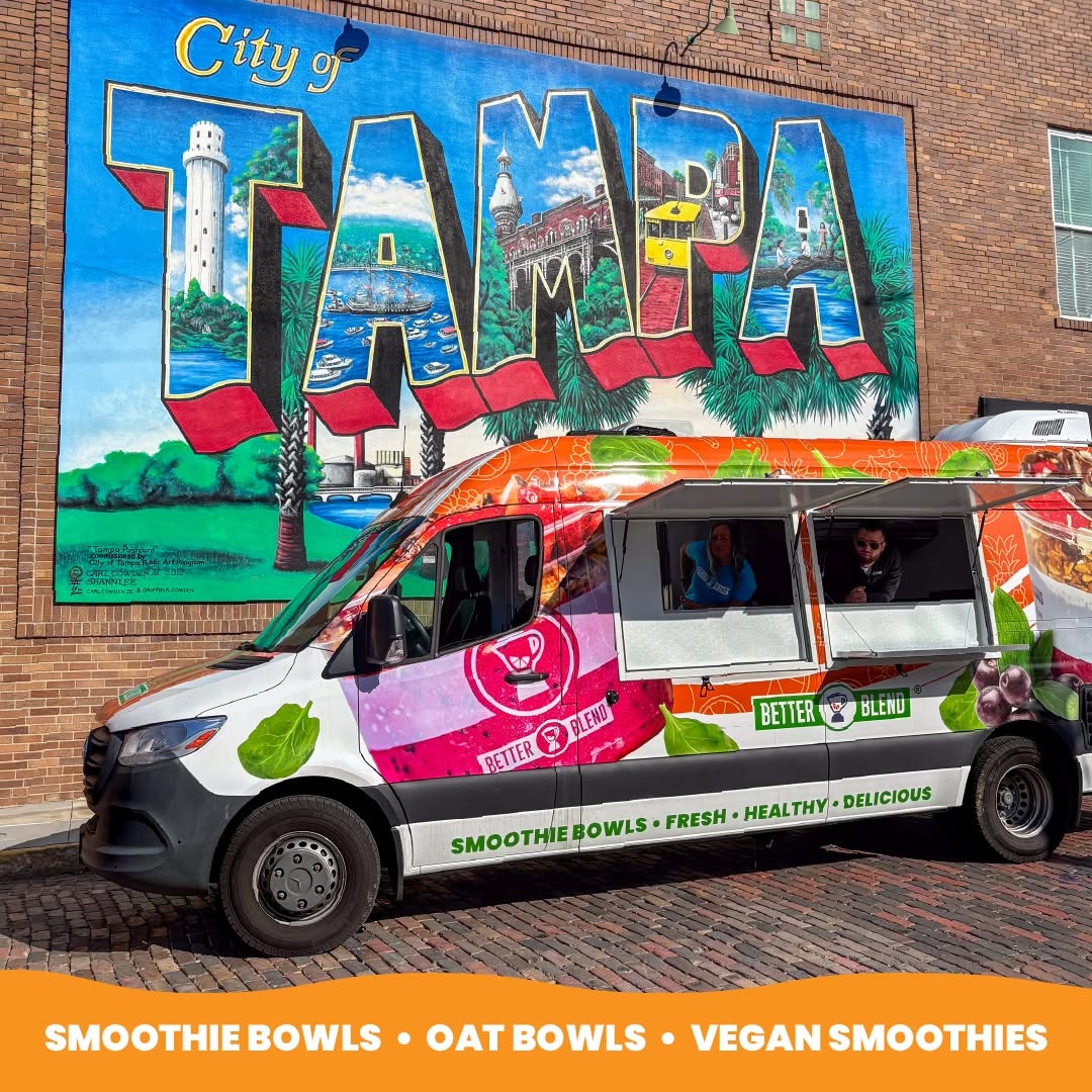 Better Blend Blendmobile food truck parked in front of the City of Tampa mural, wrapped in the brand's smoothie bowl, oat bowl, and vegan smoothie graphics.