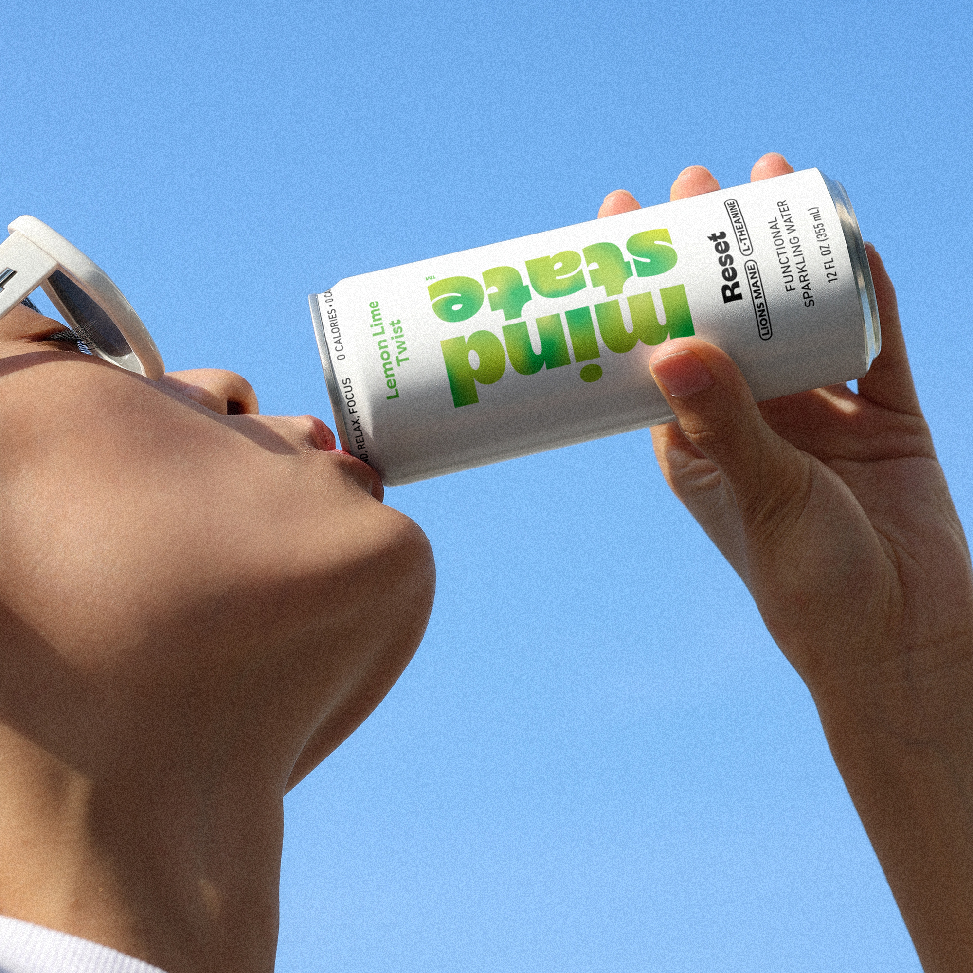 Reset Lemon Lime Twist held against an off-white wall — Mindstate lifestyle photography