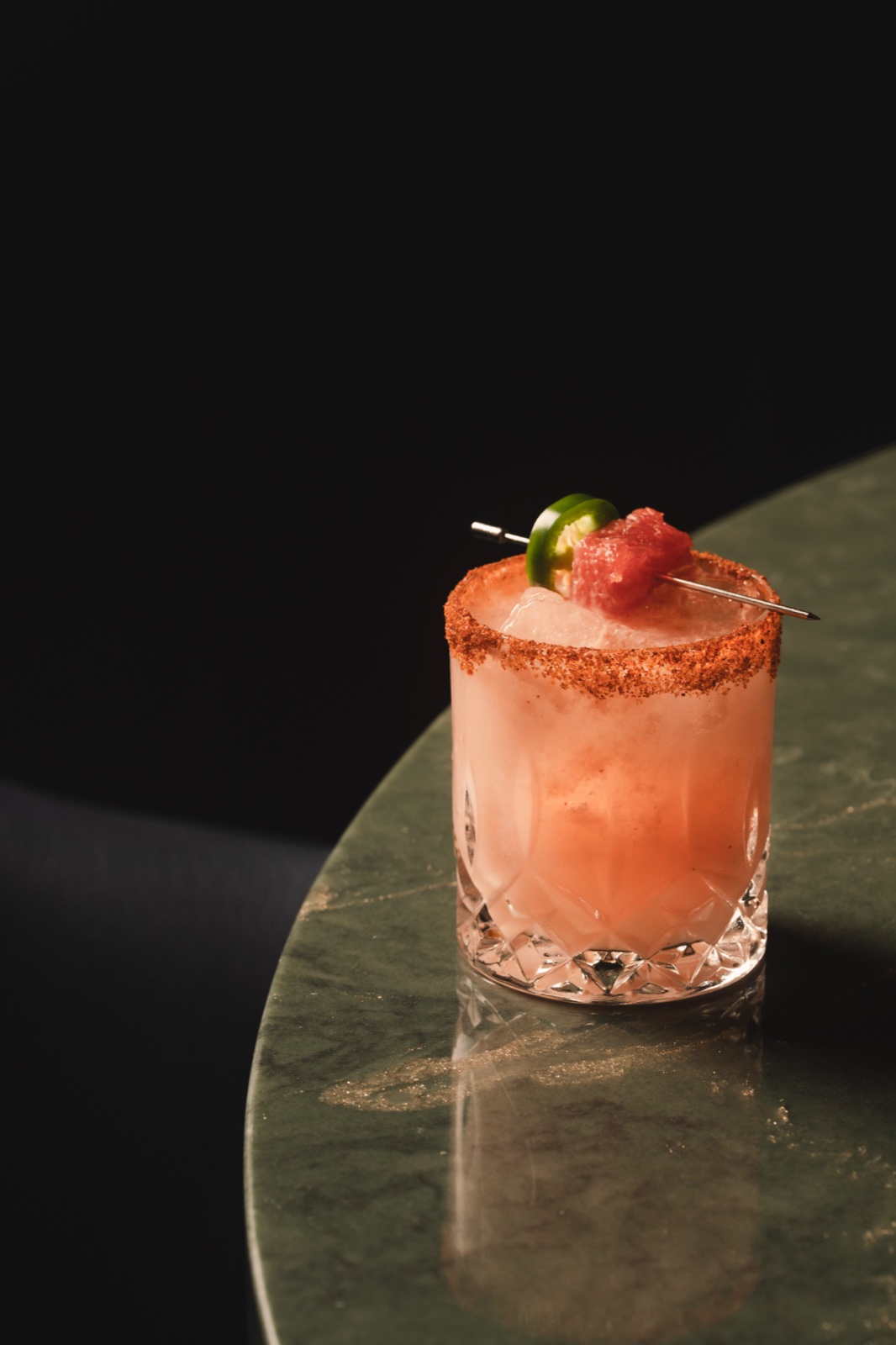Spicy margarita with jalapeño on green marble