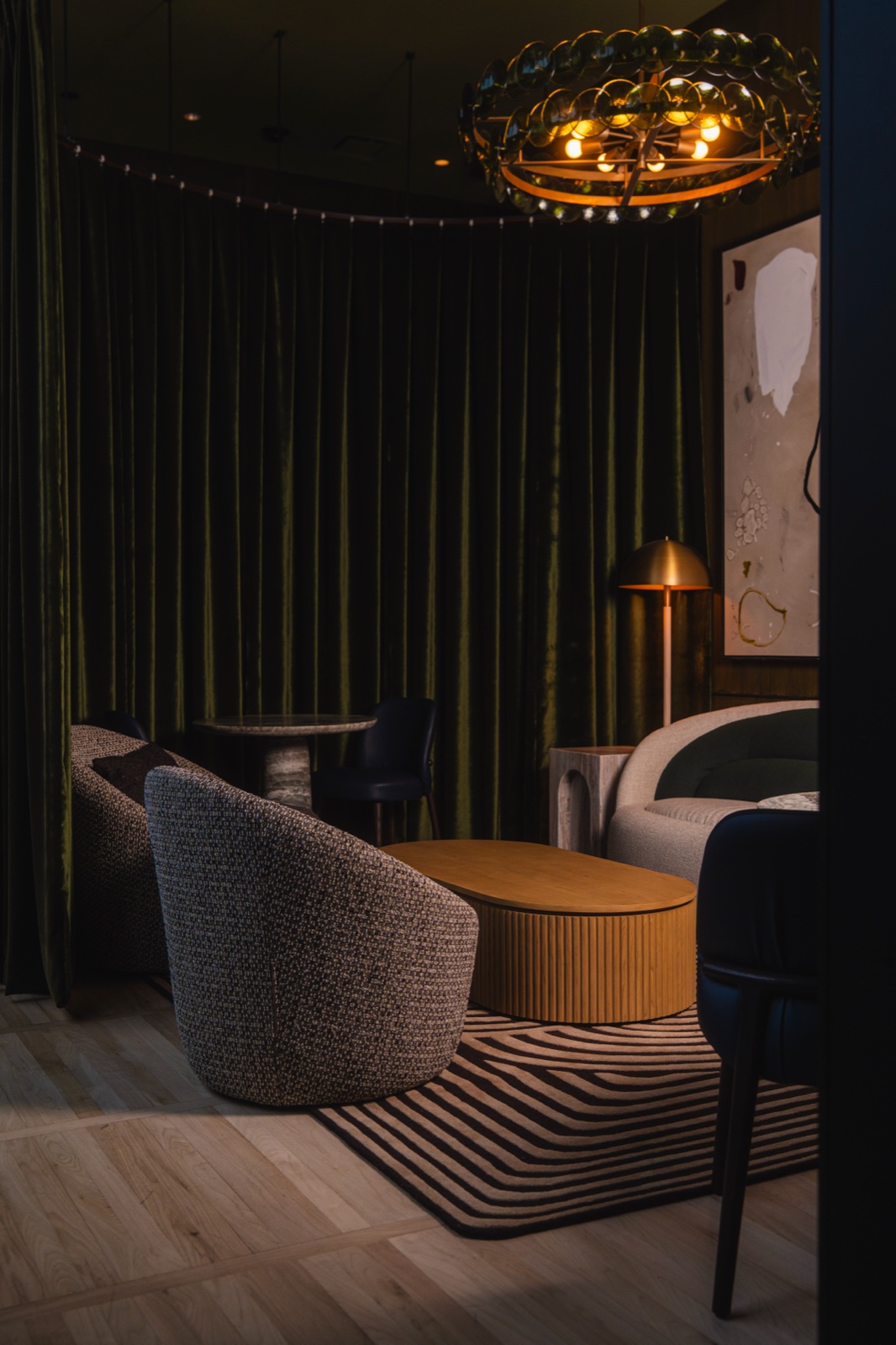 Velvet-curtained lounge beneath a crystal chandelier
