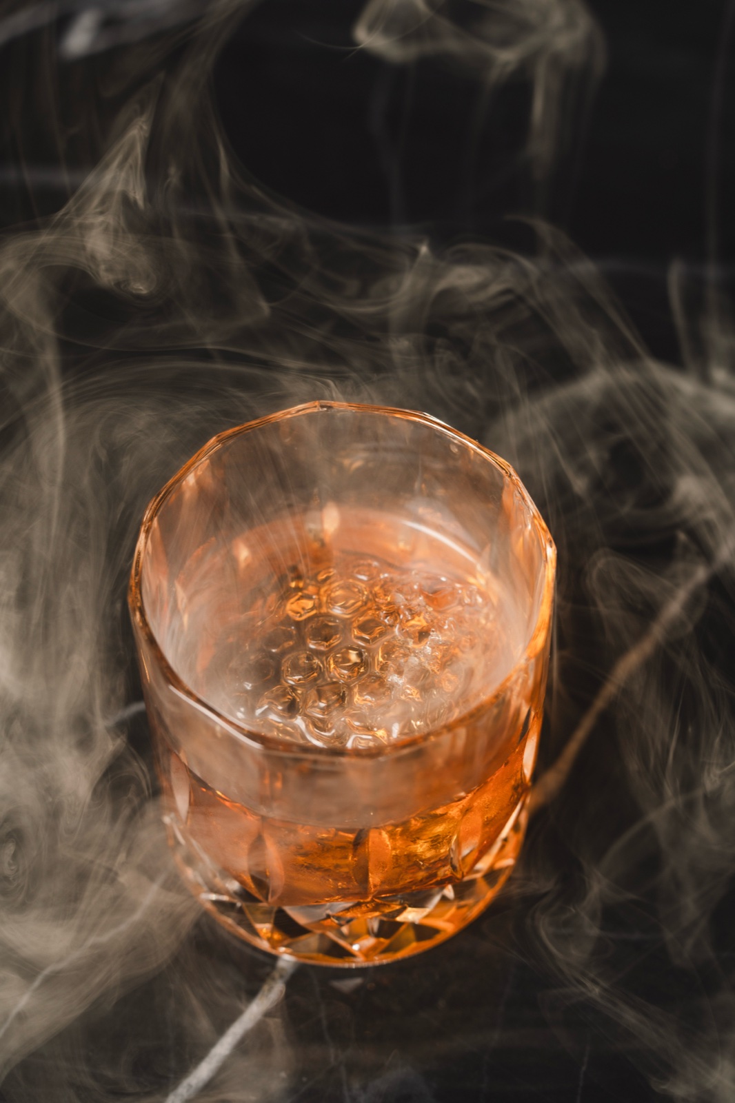 Smoked old fashioned wreathed in swirling smoke