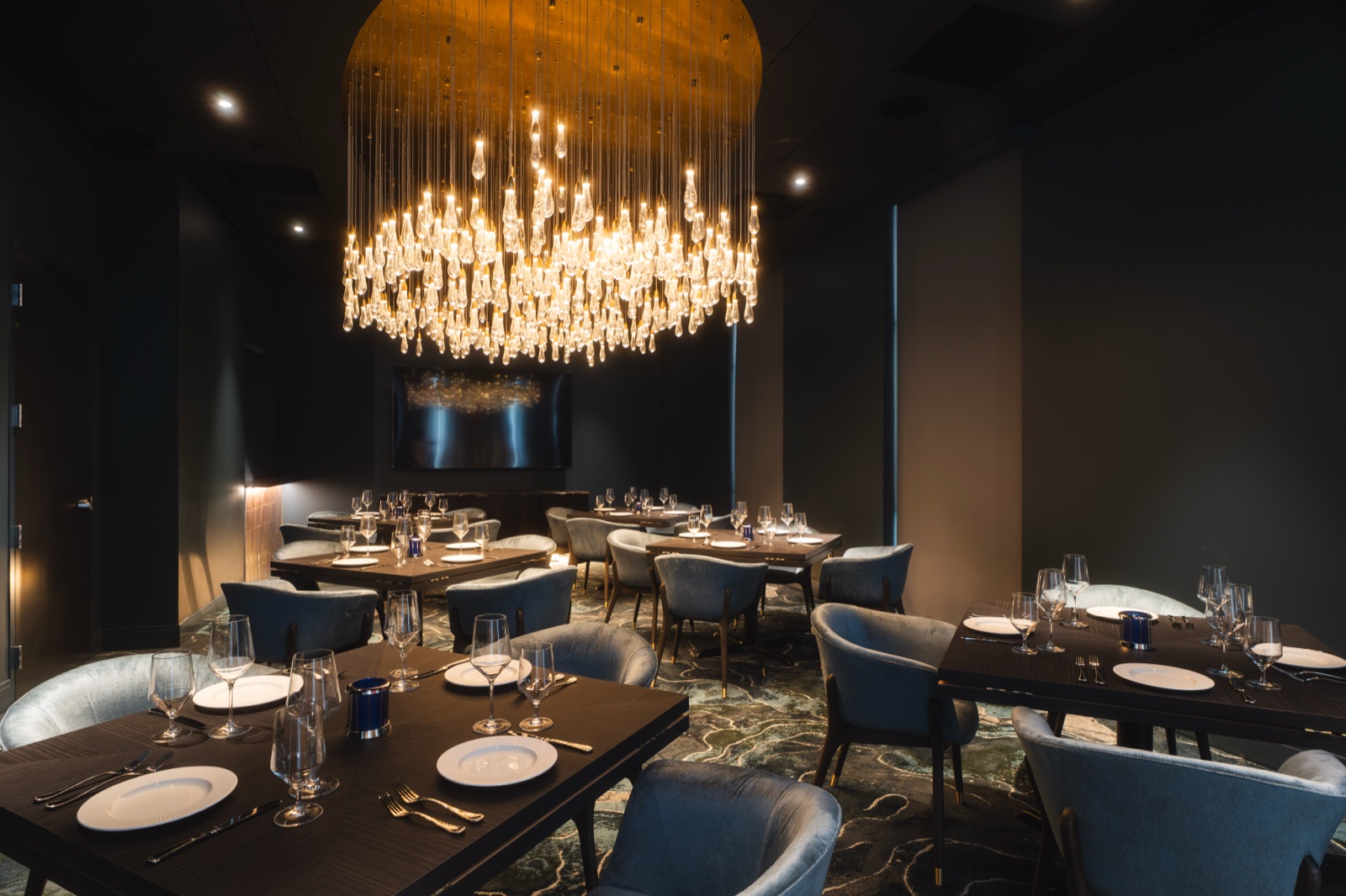 Dining room under a cascading crystal chandelier