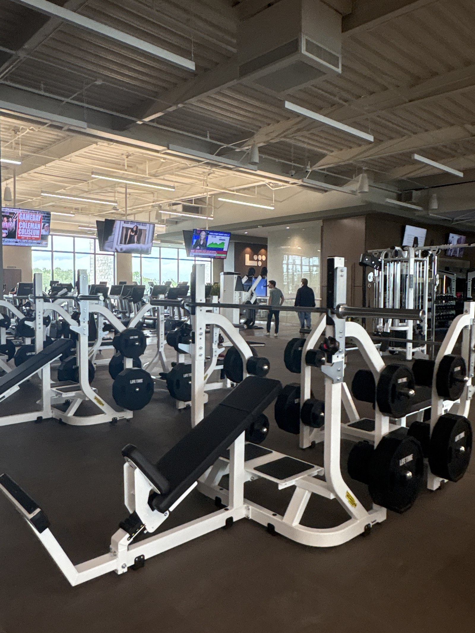 Plate-loaded strength machines and benches on the fitness floor.
