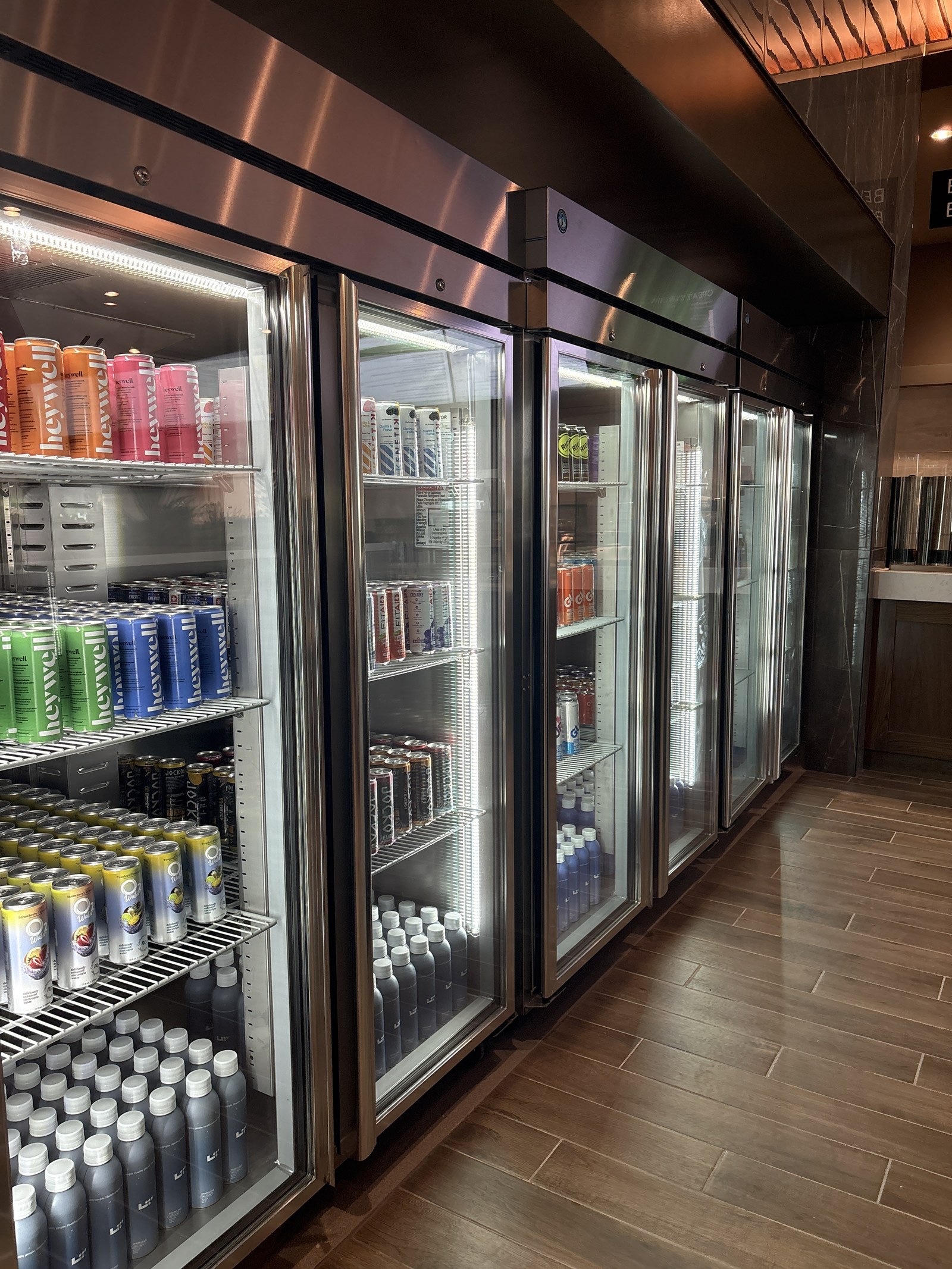 Glass-door coolers stocked with energy drinks and bottled water.